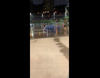 Guy girl play ping pong rain night