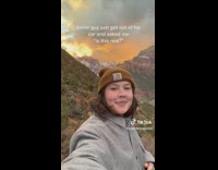 Woman records herself with beautiful view in background