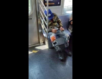 Man asleep spills drink inside the train