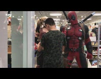 Guy touching harley quinn statue in store 