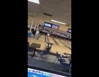 Guy throws bowling ball and gets strike 