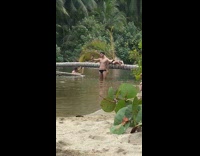 Man in Swim Brief Takes Selfie on Shallow Water