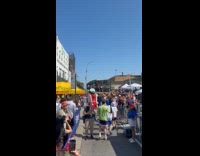 Hot dog mascot wave at people crowd contest