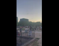 Woman with hand behind her head selfie in front of Eiffel Tower