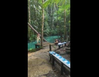 Woman thin dress poses by the river