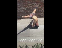 Shirtless man handstand yoga pose curved back