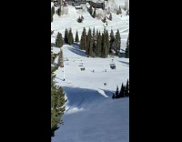 Skiier flip jumps but does not land correctly and falls on head