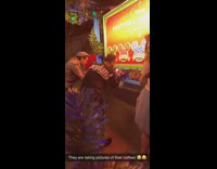 Two guys photograph drinks disneyland red sign