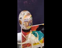 Collab BitchMP - Buddha statue holds up glass cup against shelf 