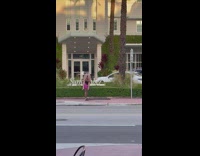 Guy walk street carry woman on shoulder