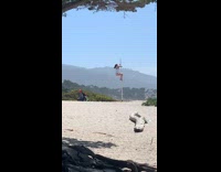 Woman white bikini pole dance spin beach