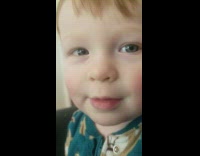 Baby boy green pajamas play and speak gibberish