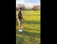 Man throws golf club bag to friend