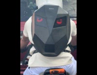 Man rides motorcycle wears LED knight backpack 