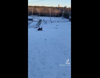 Two people sled down snow hill fail