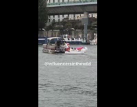 Two guys sit unicorn float river boat