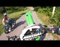 Guy does wheelie but crashes into another dirt bike and falls