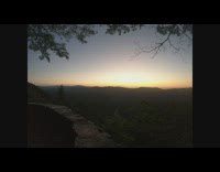 Time Lapse of sun rises behind mountains
