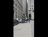 Giant inflatable rat on sidewalk