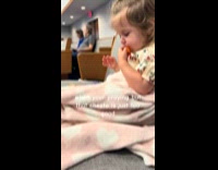 Toddler eating cheetos while praying at church