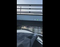 White gondola boat goes under low bridge 