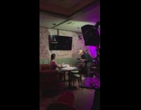 Woman in a promotional shoot part on the bar