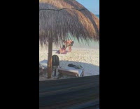 Woman lay on mat beach hut roof