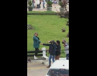 Woman green jacket hold hand church bench