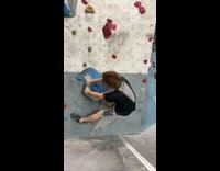 Guy rock climbing starts and falls over blue rock  