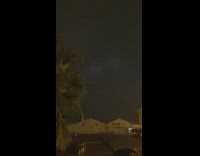 Cloud flickers by the Lightning behind it