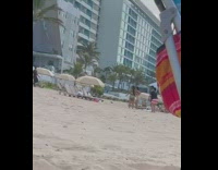 Friends in beach attire tiktok dance at the beach