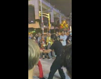 Guy lifts red pants lady does splits 