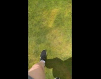 Woman step on squishy grass water bubble