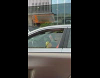 Collab winy - Man plays yellow maracas inside his car 