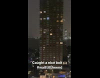 Large lightning bolt flashes above river water