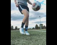 Brown kitten interrupts girl soccer ball park