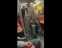 Two guys wrestle on subway train, guy gets pinned down taps out, gives WWE wrestling belt to friend