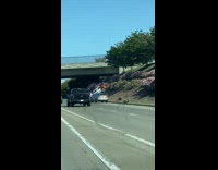 Two cars stuck on the side hill of the highway road