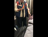 Guy reading book wears f train shirt on the f subway train