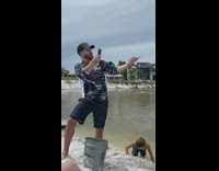 Black white sweater guy holds photographs crab 