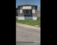 White tesla car parked in trailer park home area