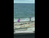 Guy grey sleeves jump shot beach laugh