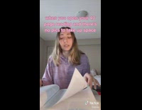 Girl turning pages of book reading through book