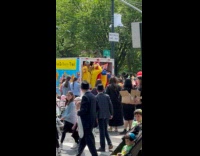 Clown parade dances and celebrates in street