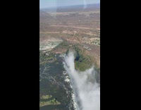 Lady Flies Over Waterfalls at Vast Desert
