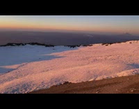 Guy hikes around crater during sunrise