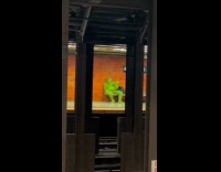 Collab Subway Creatures - Man on subway platform wearing grinch costume