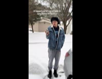 Man black cap holds camera for filmer