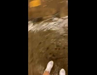 People walk up wet stairs while others watch 