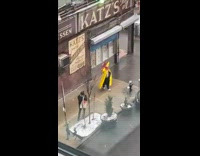 Yellow coat guy with red mcdonalds flag 